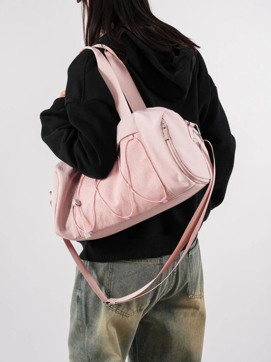 Large Waterproof Sports Bag in pink, worn crossbody over the shoulder